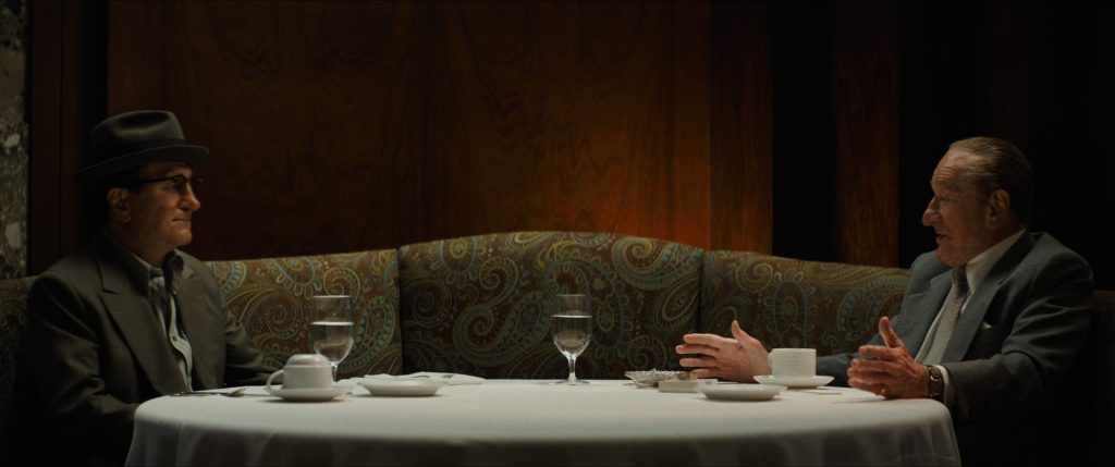 De Niro as two characters sat at a dining table