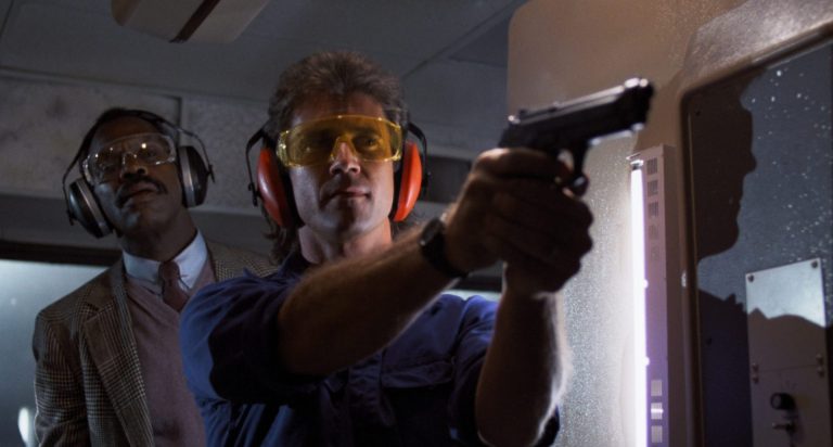 Mel Gibson and Danny Glover at a firing range in Lethal Weapon.