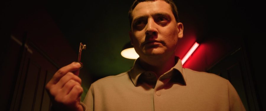 A man holding a key in a scene from Past Life