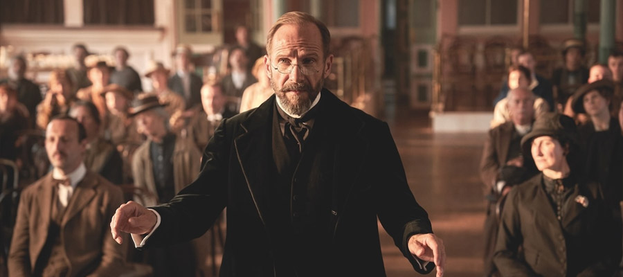 Ralph Fiennes conducts in a still Alan Bennett's The Choral.