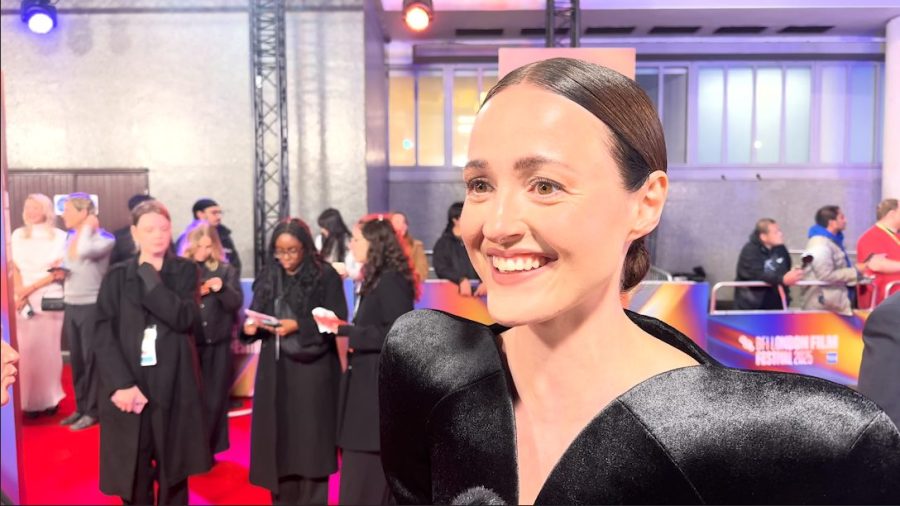Renate Reinsve smiling as she's doing an interview on the red carpet.