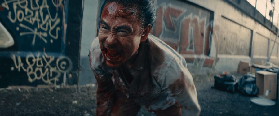 A man covered in blood and screaming in a scene from Syphon