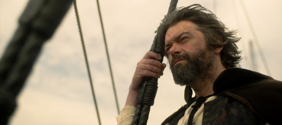 Caravaggio peers from the deck of a ship on his return to Rome in 1610.