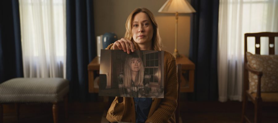 Camille Sullivan's Mia holds up a photograph of her missing sister in Shelby Oaks.