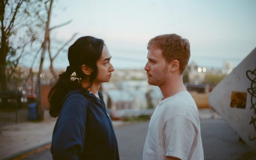 Sebiye Behtiyar and Fred Hechinger standing opposite each other in Preparation for the Next Life
